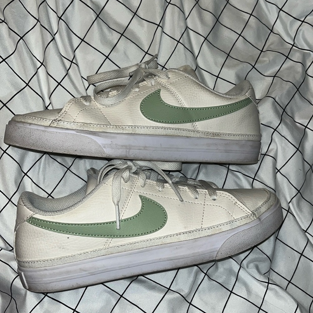 Woman’s sage green nikes.